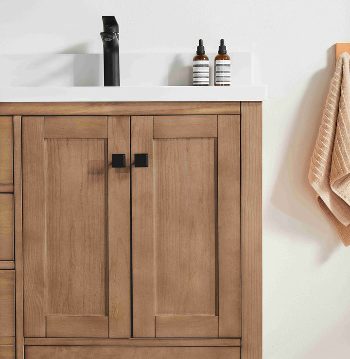 Wooden bathroom vanity with white countertop and decorative items.