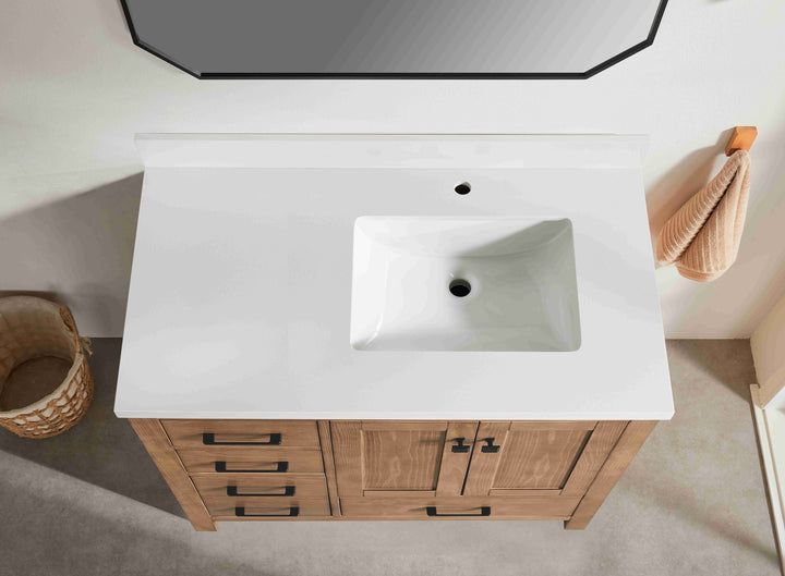 Bathroom vanity with white countertop and wooden cabinets.