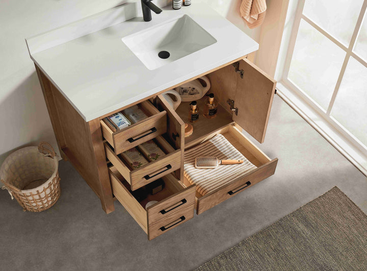 Bathroom vanity with open drawers and a sink, featuring various toiletries.