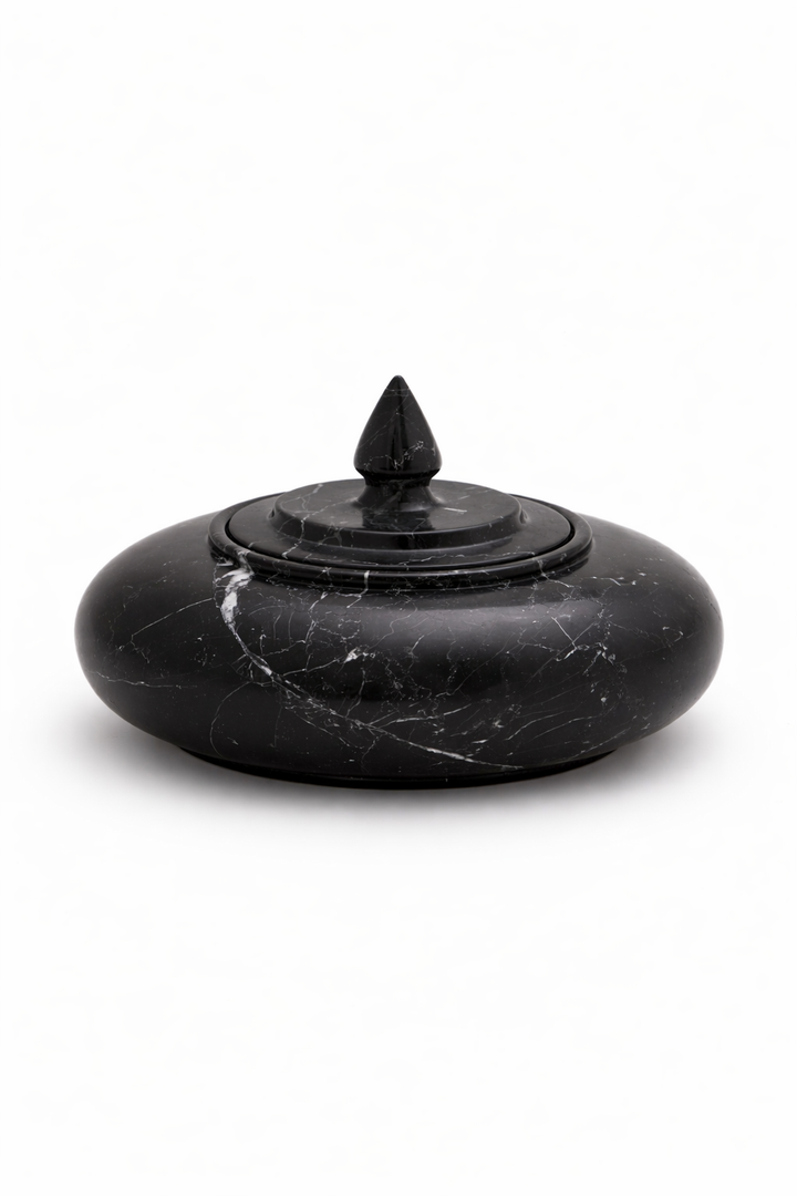 Black marble incense burner with a pointed top on a white background