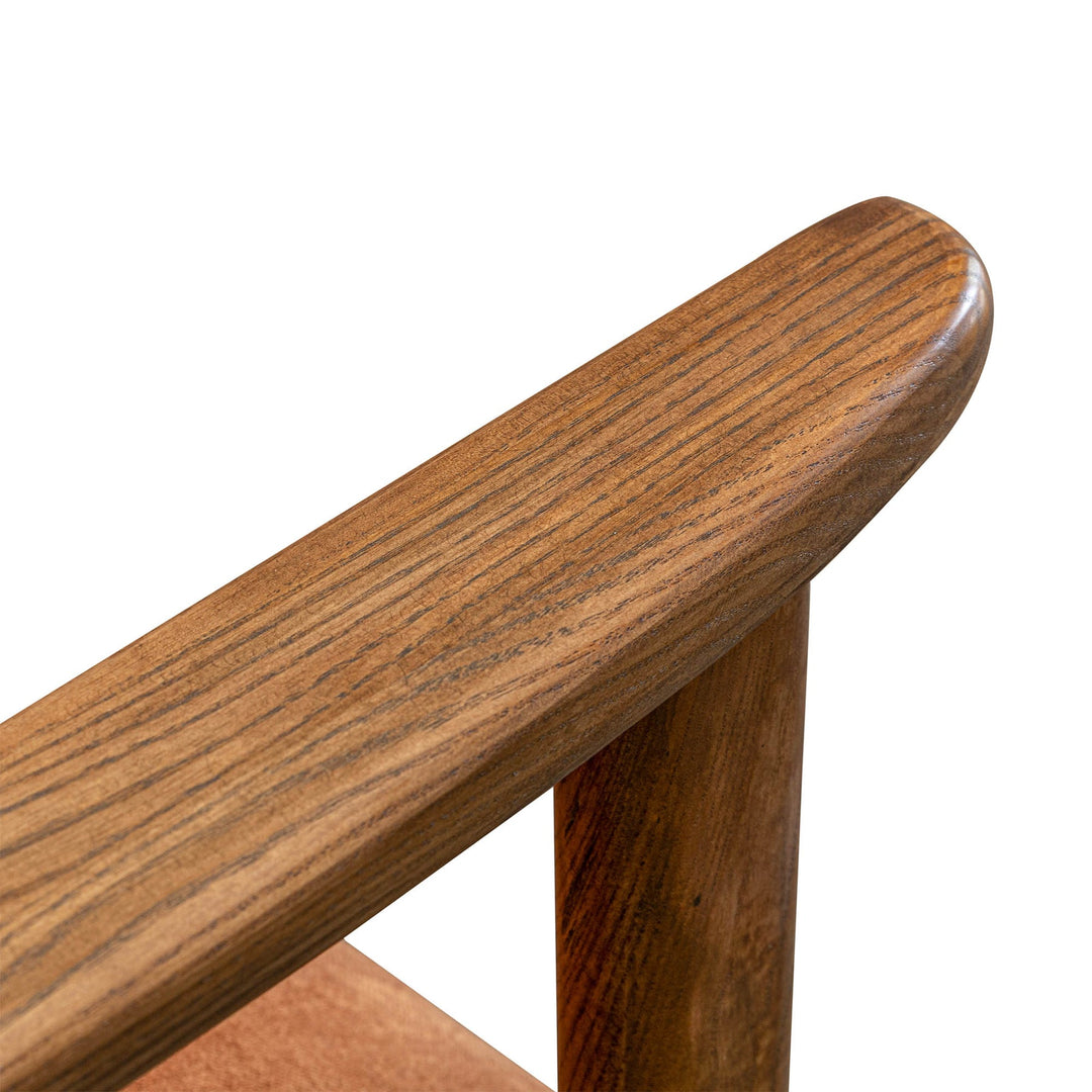 Close-up of a wooden chair armrest on a white background
